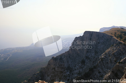 Image of Top of the mountain with green forest above