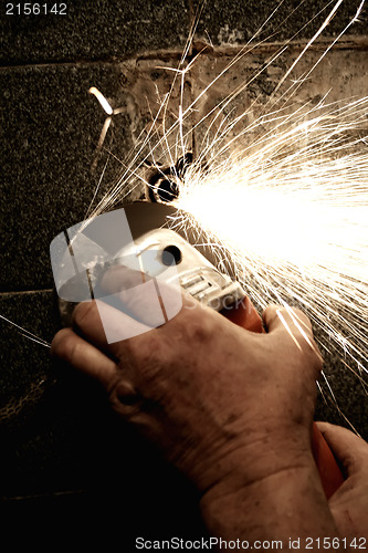 Image of Sparks from a worker grinding steel