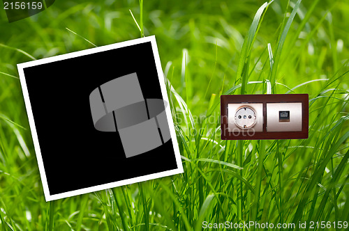 Image of Energy outlet in grass with empty frames.Environment concept.