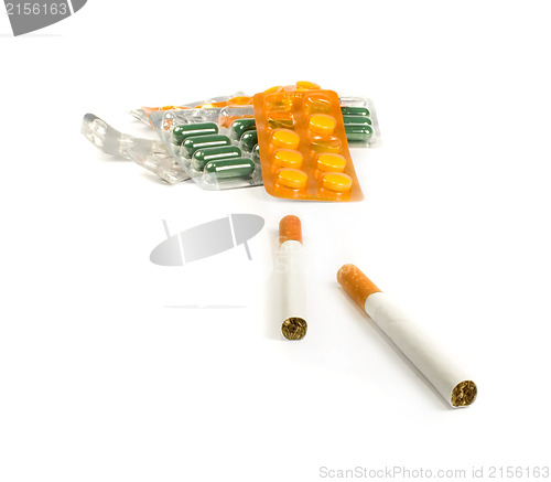 Image of Cigarettes and pills isolated.Illnesses from cigarettes concept