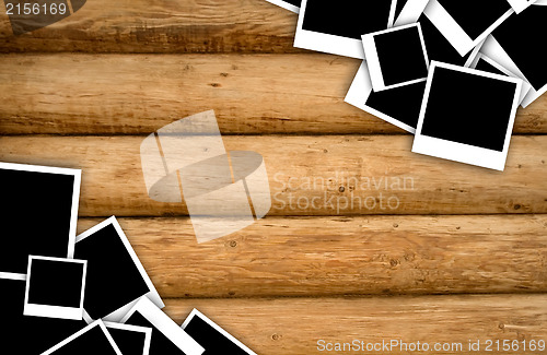 Image of Empty instant photos on grunge wood background