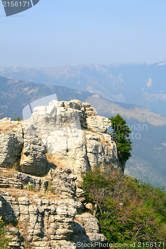 Image of Top of the mountain with green forest above