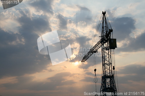 Image of Construction crane silhouette with cool sunset background