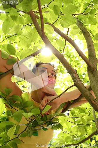 Image of Young beautiful woman outdoors in sunny park