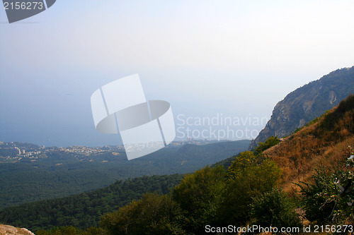 Image of Top of the mountain with green forest above