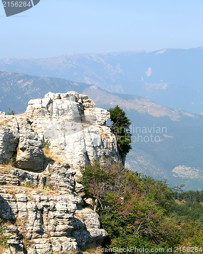 Image of Top of the mountain with green forest above