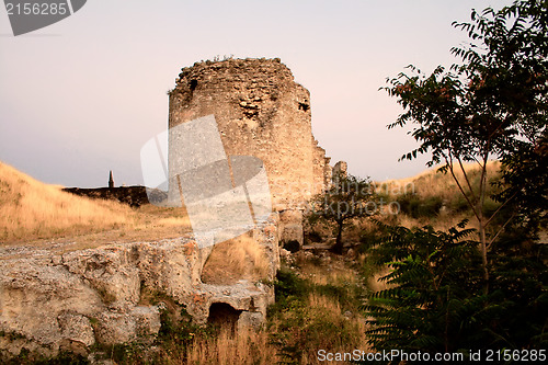 Image of Ancient ruins of brick tower during sunset.