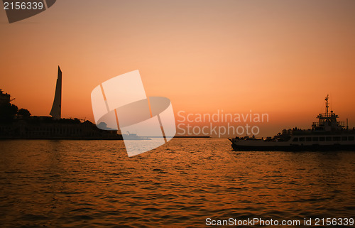 Image of Sunset sea with boat crossing the bay