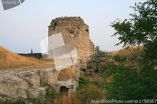 Image of Ancient ruins of brick tower during sunset.