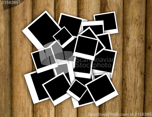 Image of Empty instant photos on grunge wood background