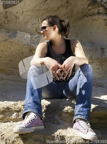 Image of Model sitting on the rocks. Urban style