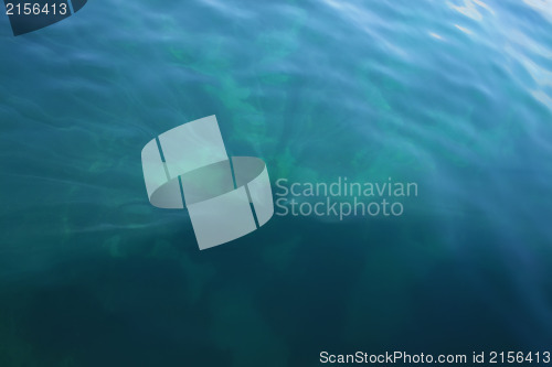 Image of Rays of light falling into the sea.Close up to the waves surface