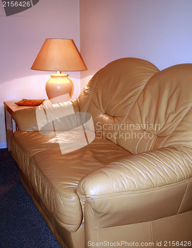 Image of Leather sofa with lamp on a table