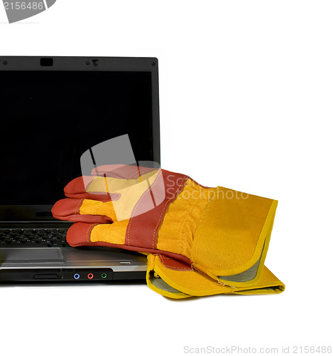 Image of Protective gloves on a laptop isolated. Empty black desktop for 
