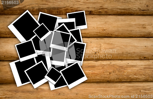 Image of Empty instant photos on grunge wood background