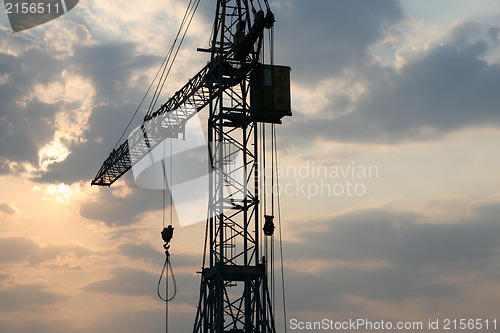 Image of Construction crane silhouette with cool sunset background