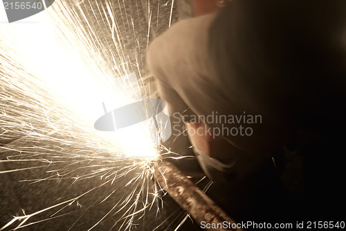 Image of Sparks from a worker grinding steel