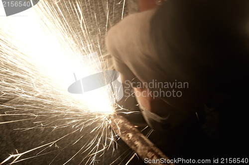 Image of Sparks from a worker grinding steel