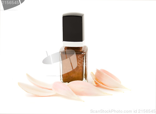 Image of Nail polish with flower petals isolated