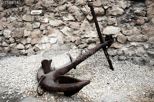 Image of Old rusty anchor on the ground