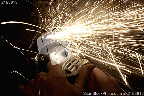 Image of Sparks from a worker grinding steel