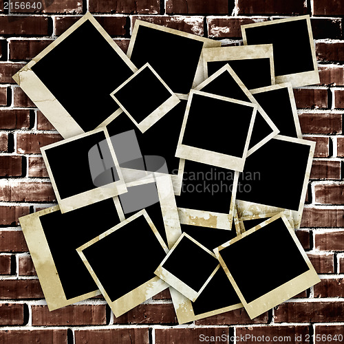 Image of Empty old photo frames on grunge brick wall background