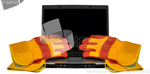 Image of Protective gloves on a laptop isolated. Empty black desktop for 