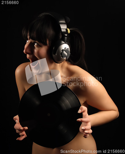Image of Naked girl with vinyl plate and headphones