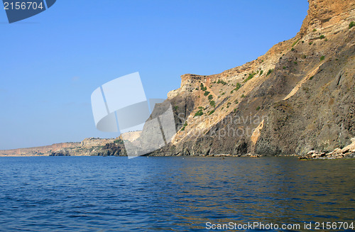 Image of Mountain on a rocky coastline.View from sea.