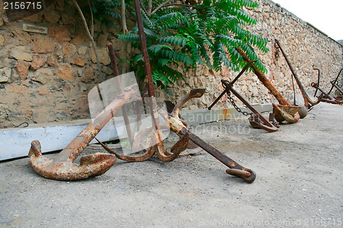 Image of Old rusty anchor on the ground