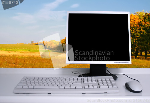Image of PC with black desktop and green field background