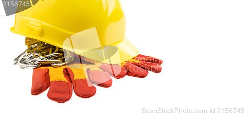 Image of Yellow hard hat, protective gloves and steel chain isolated