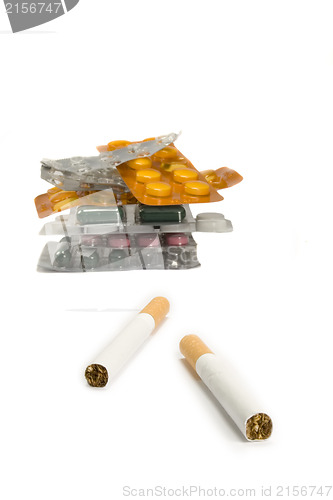 Image of Cigarettes and pills isolated.Illnesses from cigarettes concept
