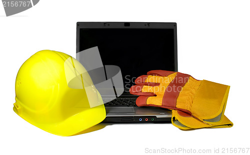 Image of Yellow Hard Hat and protective gloves on a laptop isolated.Empty