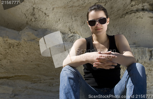 Image of Model sitting on the rocks. Urban style