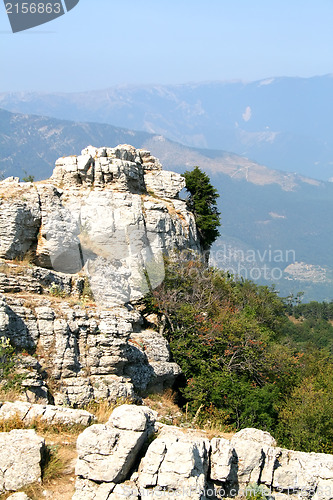 Image of Top of the mountain with green forest above