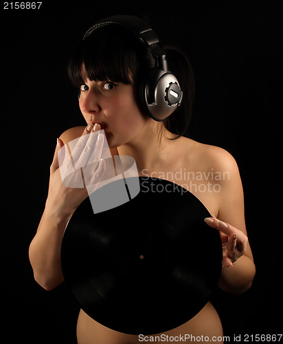 Image of Naked girl with vinyl plate and headphones