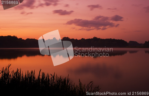 Image of Romantic sunset on the lake with fog