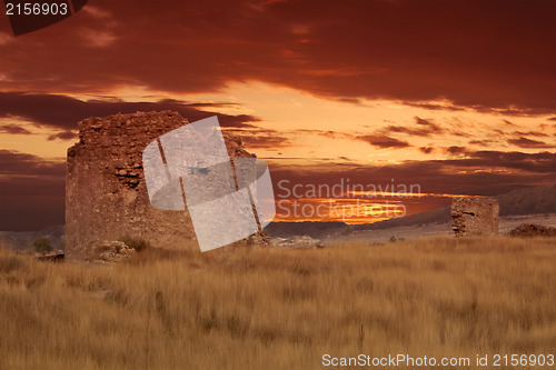 Image of Ancient ruins of brick tower during sunset.