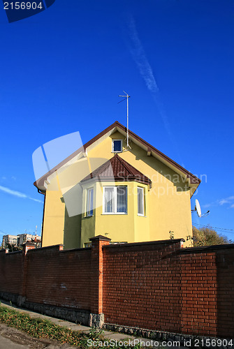 Image of Yellow house among blue sky