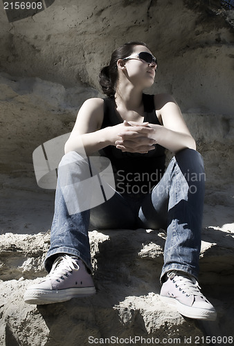 Image of Model sitting on the rocks. Urban style