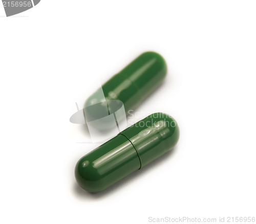 Image of Two green pills isolated