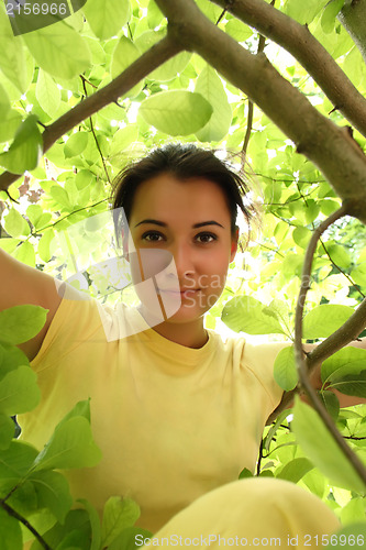 Image of Young beautiful woman outdoors in sunny park