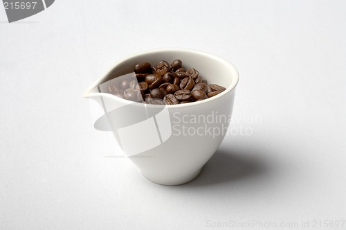 Image of cup full of colombian coffee beans