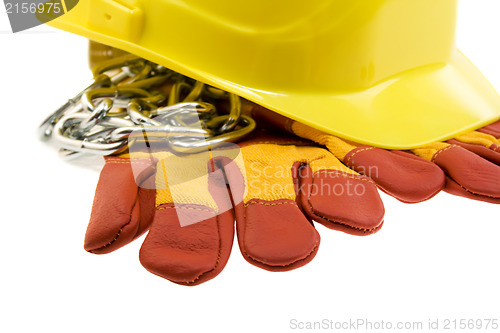 Image of Yellow hard hat, protective gloves and steel chain isolated