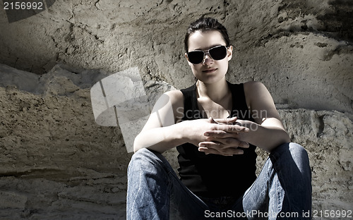 Image of Model sitting on the rocks. Urban style