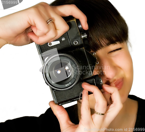 Image of Young beautiful smiling woman holding a photo camera