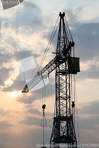 Image of Construction crane silhouette with cool sunset background