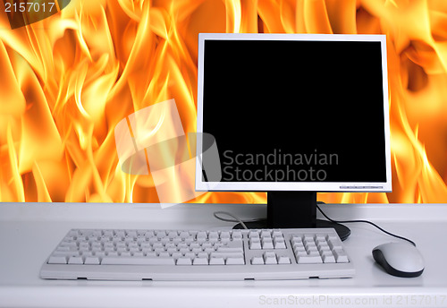 Image of PC with black desktop and fire flames background