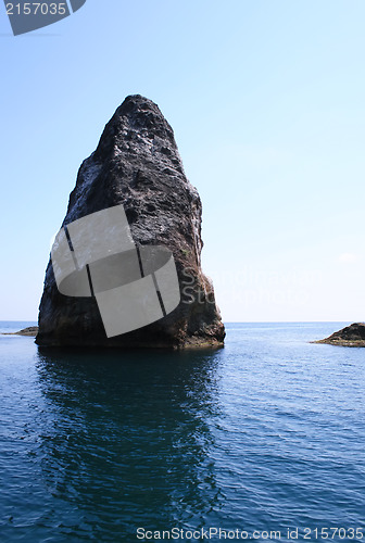 Image of Rocks and endless sea with clear blue sky